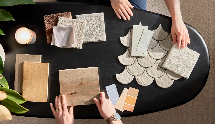 Flooring and countertop samples spread on a table